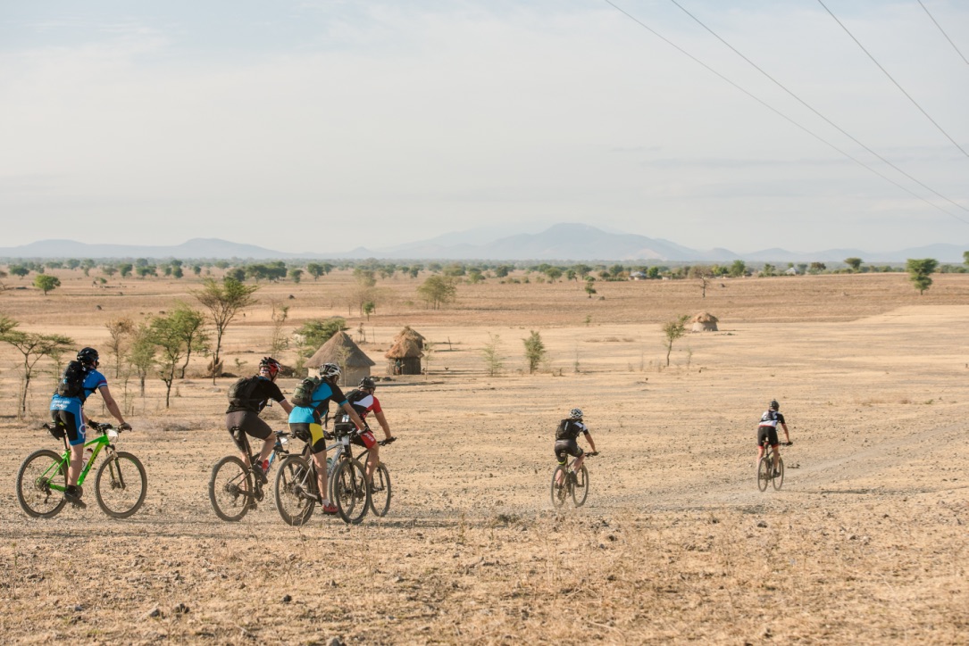 cyclists, savanne, masai house, Kilimanjaro Bike Trail